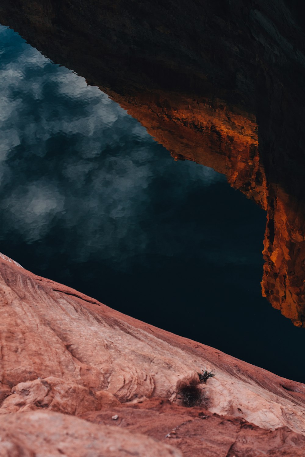 brown rock formation under white clouds