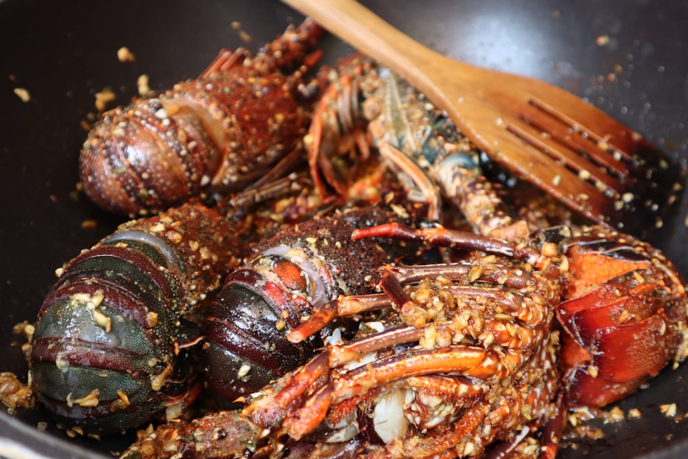 brown and red lobster on brown wooden fork