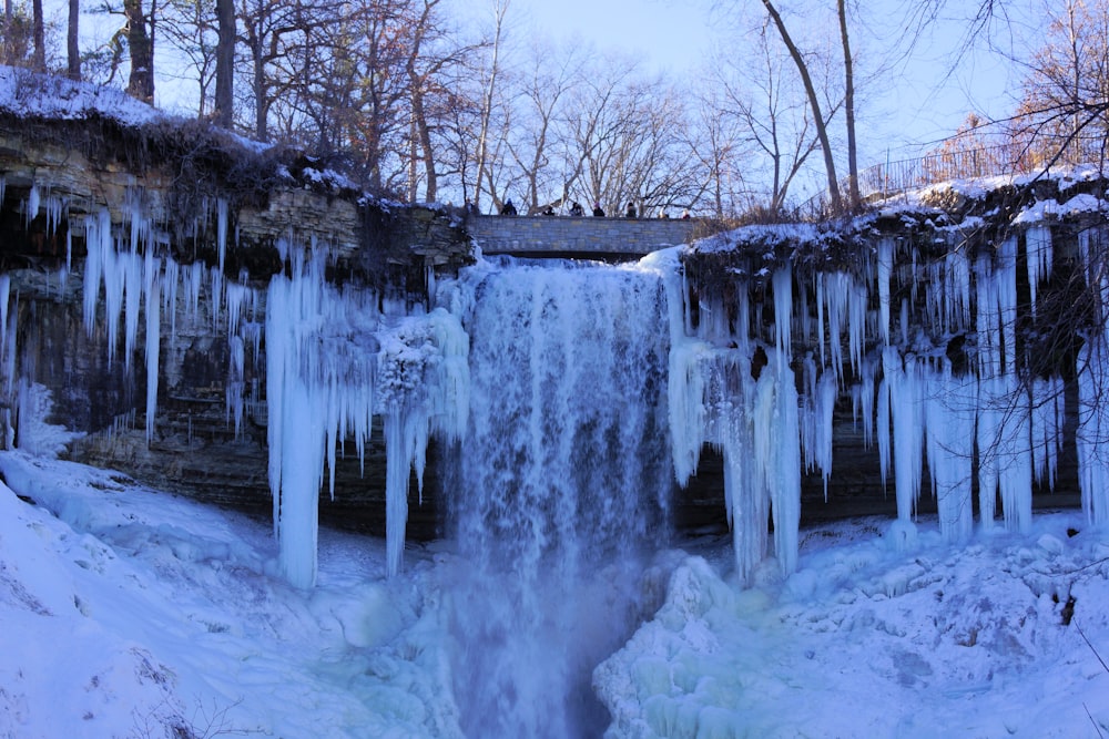 water falls in the middle of snow covered ground