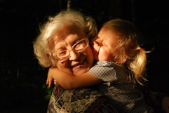 woman in black and white striped shirt hugging girl in black and white striped shirt