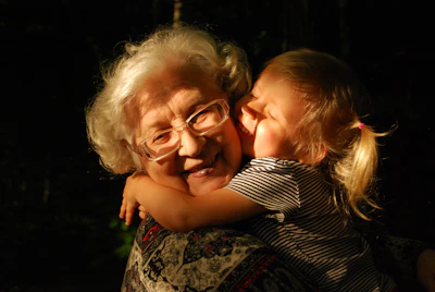 A grandmother warmly embracing her granddaughter