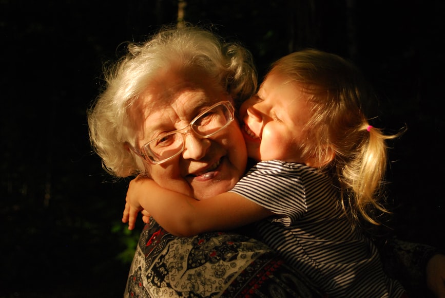 A Grandma Hugging Her Grand Daughter When She Is Struggling To Cope With Losing A Loved One