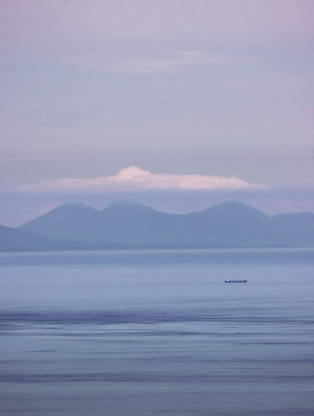 boat on sea near mountain during daytime