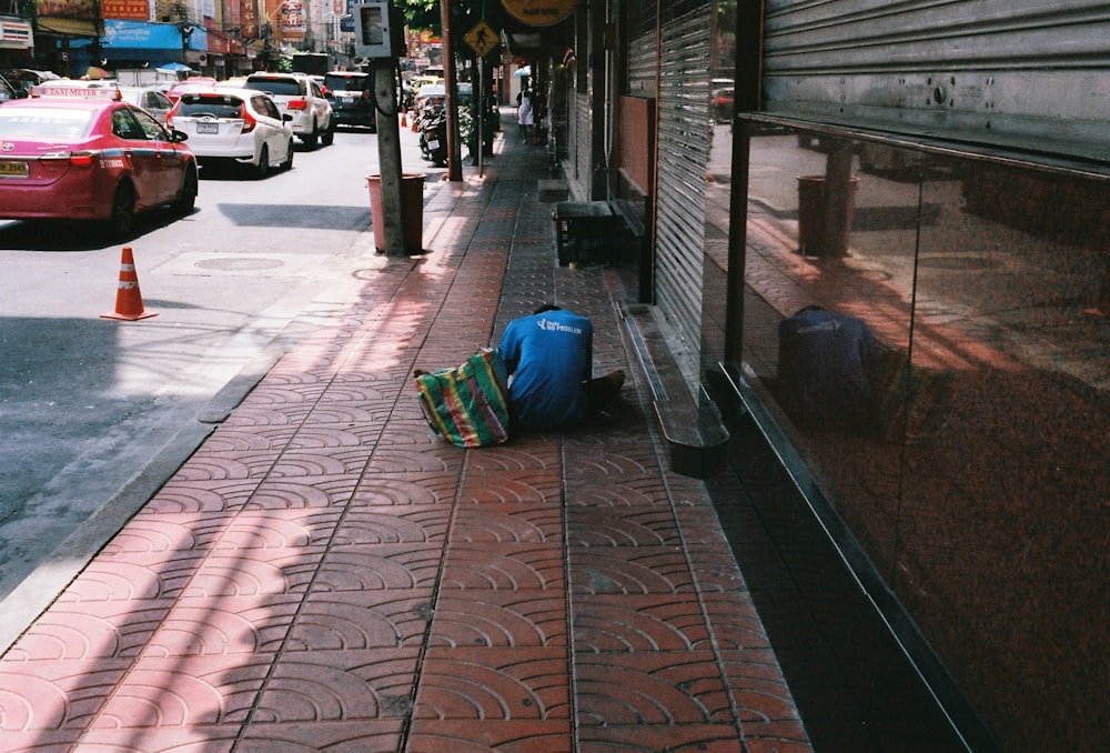 blue plastic container on brown and white floor tiles