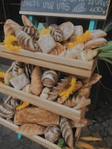 A display of freshly baked artisan breads and colorful pastries arranged on rustic trays.
