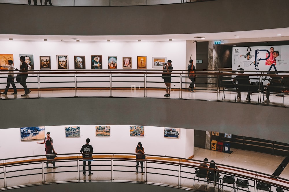 people walking on staircase inside building