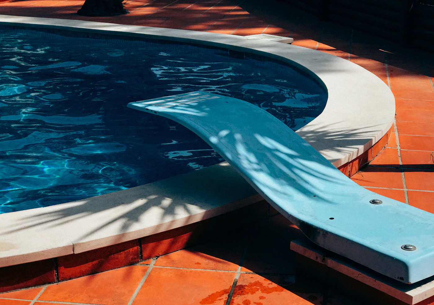 Clear blue residential swimming pool on a sunny day