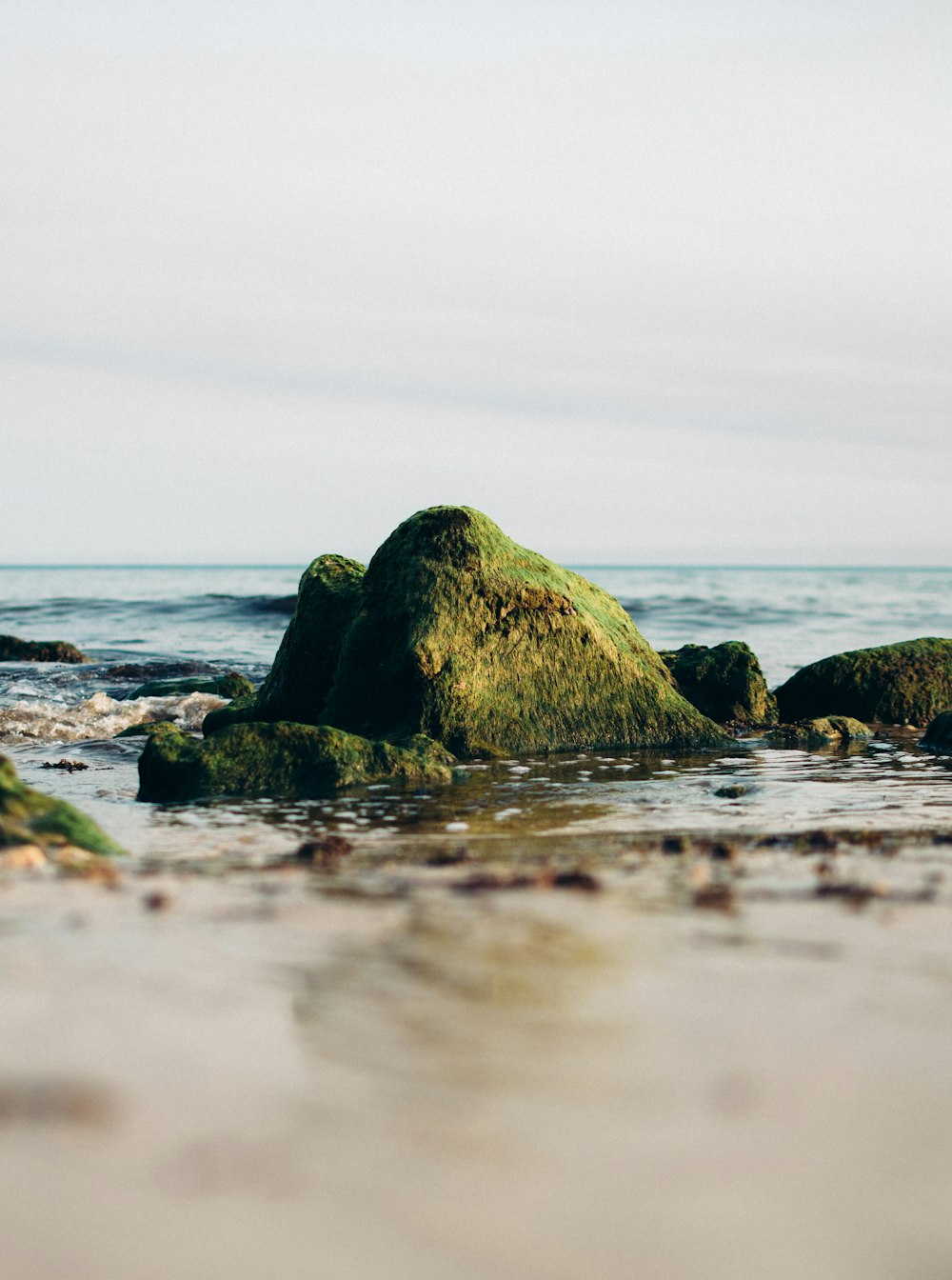 brown rock formation on sea water during daytime