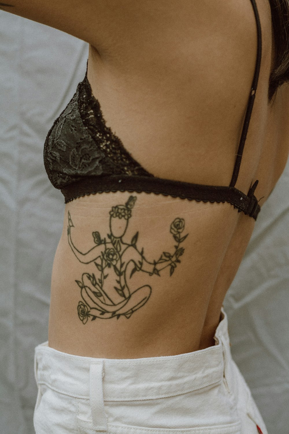 woman with black floral tattoo on her back