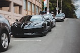A sleek black sports car parked on a city street.