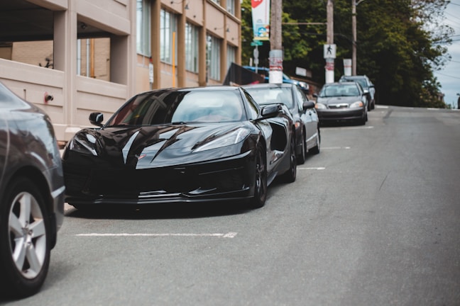A sleek black sports car parked on a city street.