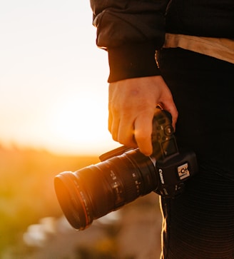 person holding black dslr camera