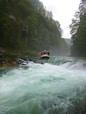 person riding orange kayak on river during daytime