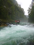 person riding orange kayak on river during daytime