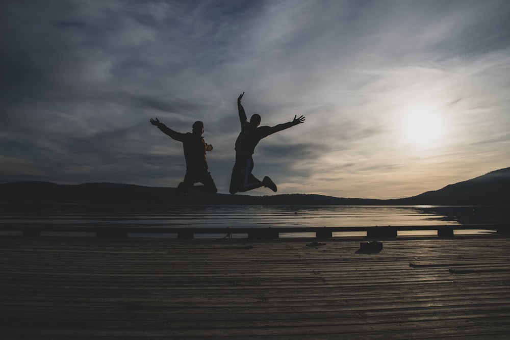 a couple of people jumping in the air