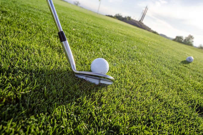 Young golfer practicing at the driving range