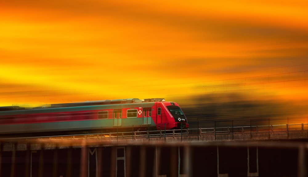 red and white train on rail during sunset