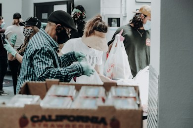 Volunteers sorting fresh food for neighbors