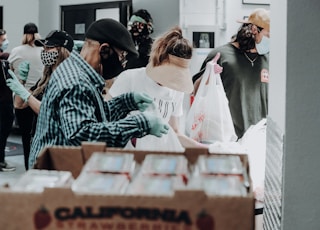 people standing in front of brown cardboard boxes