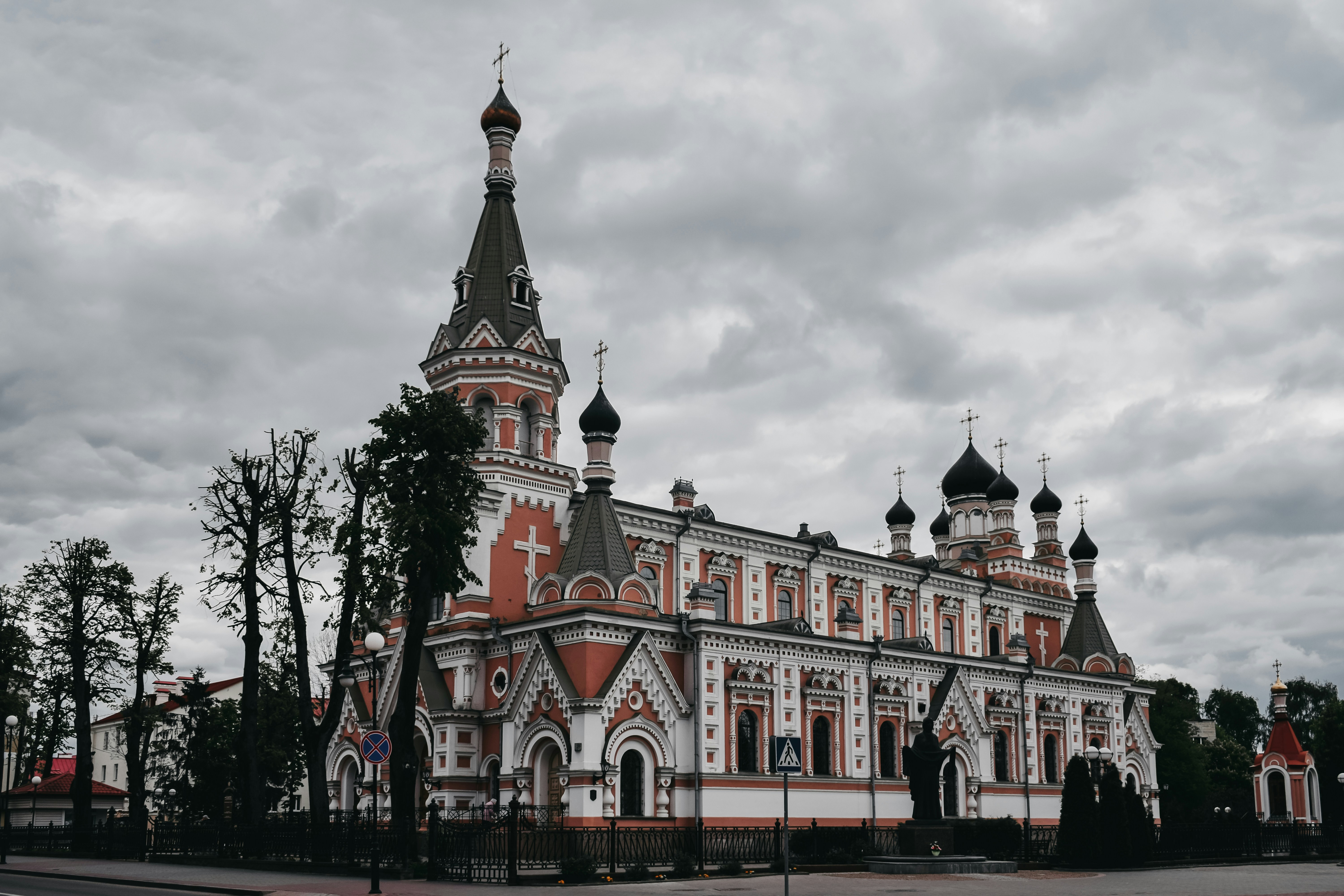 red and white concrete building under cloudy sky during daytime