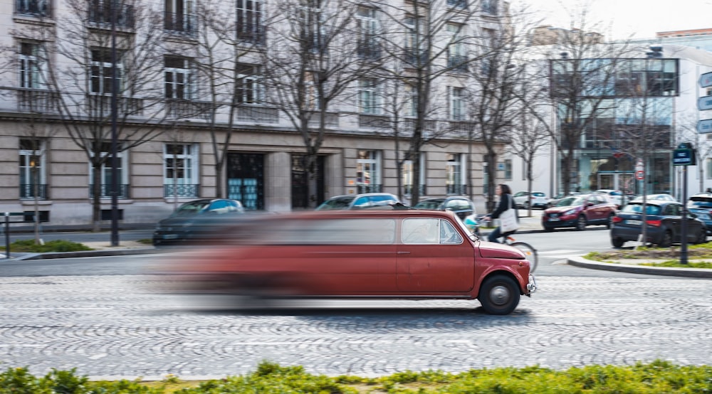 red sedan on road during daytime