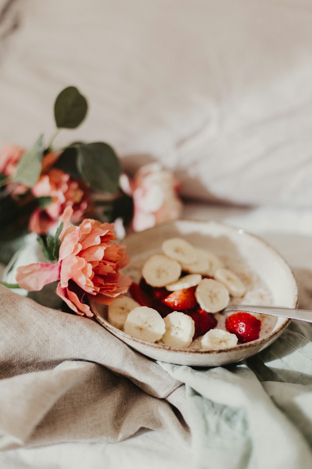 red and white round fruits on white ceramic bowl