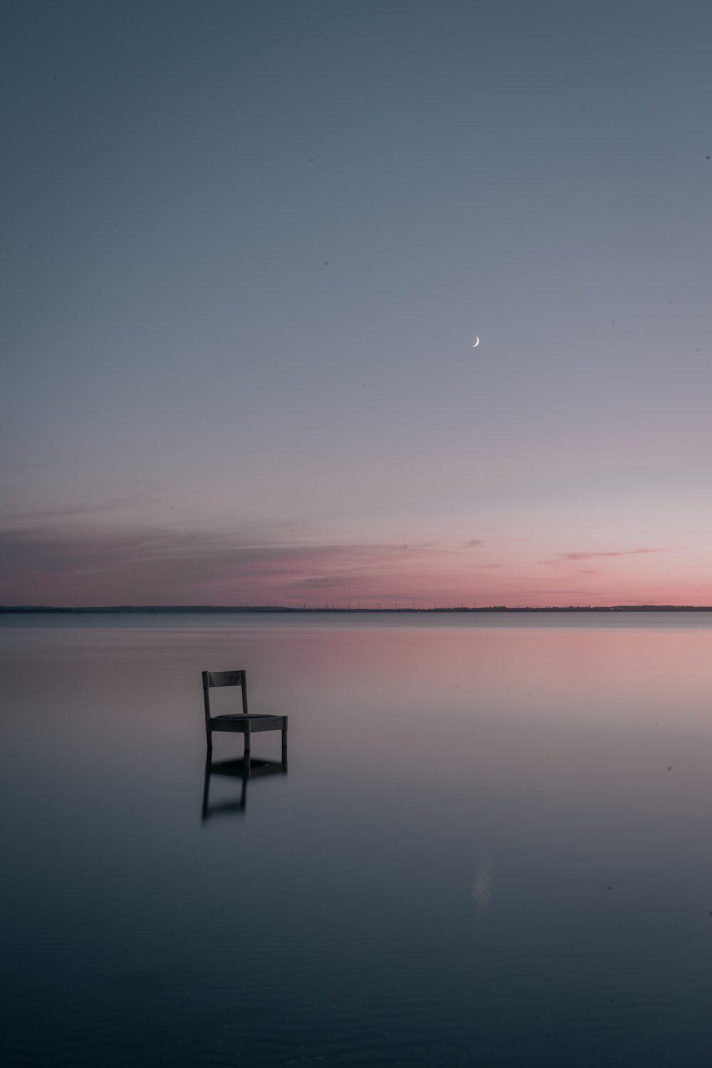 brown wooden dock on calm water during sunset