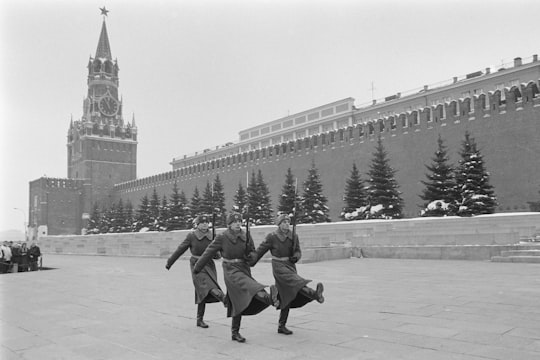 grayscale photo of people walking on street in Red Square Russia