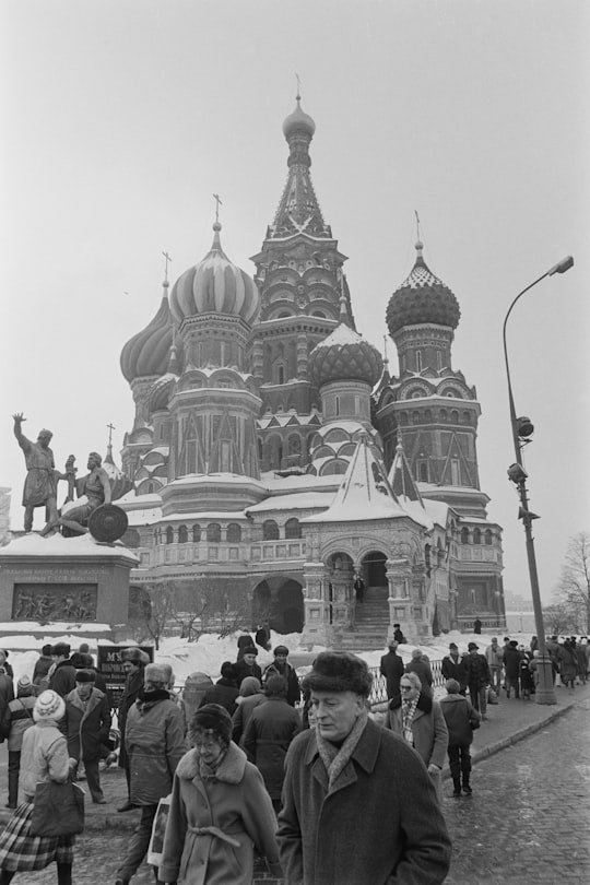 people walking near dome building during daytime in Saint Basil's Cathedral Russia