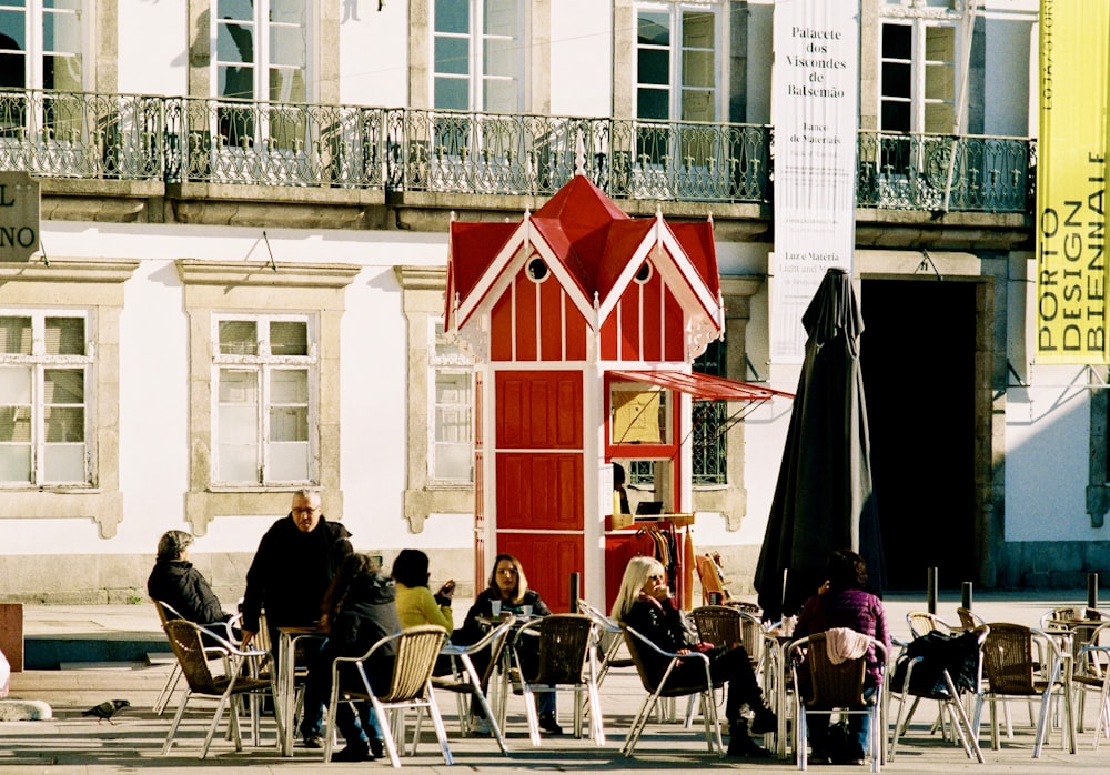 people sitting on chairs near building during daytime