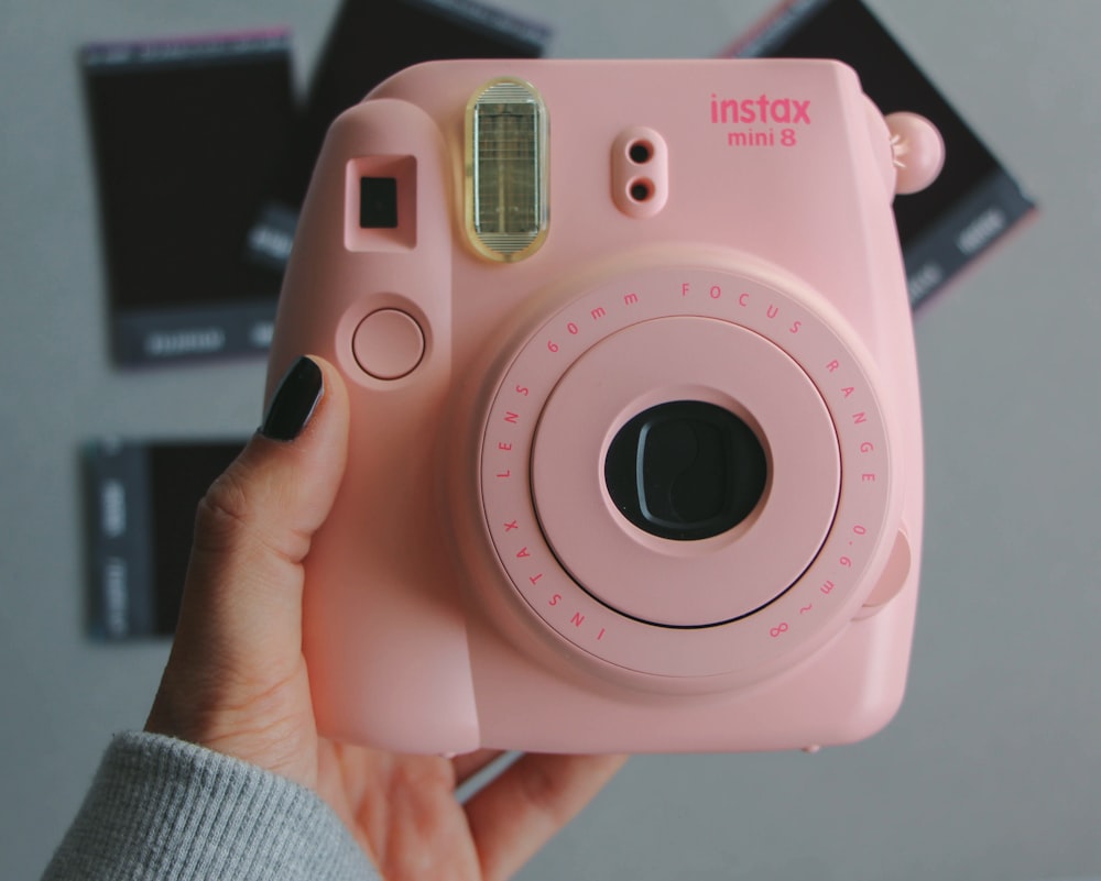 pink and white sony camera