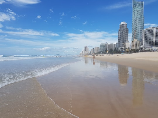 city skyline across the sea under blue and white cloudy sky during daytime in Surfers Paradise Beach Australia