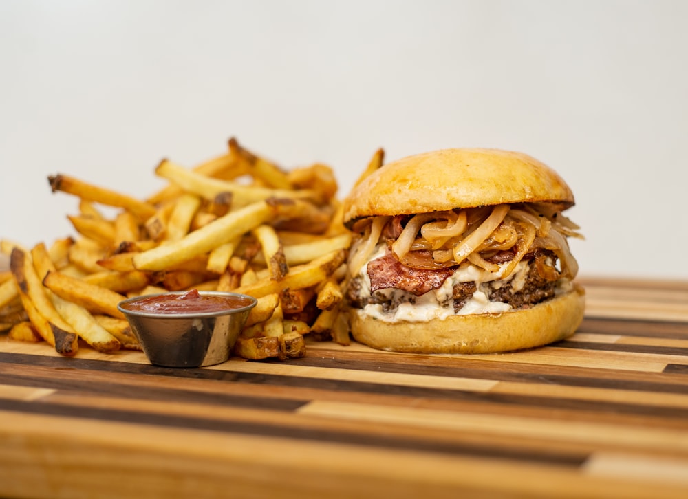 burger and fries on brown wooden table