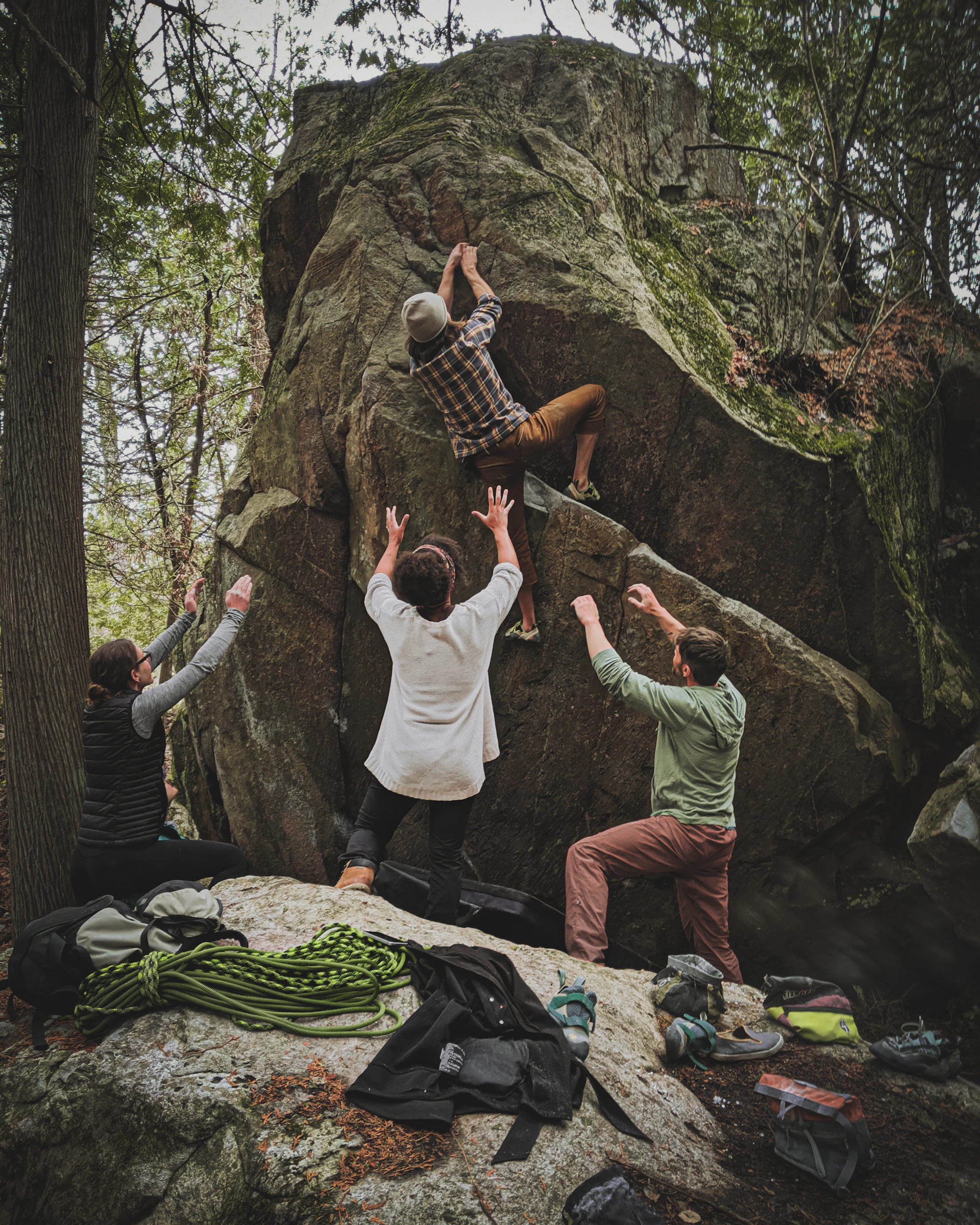 A group of climbers bouldering with crash pads