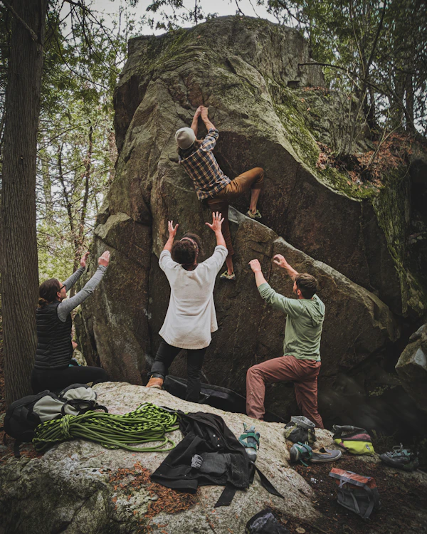 A group of climbers bouldering with crash pads