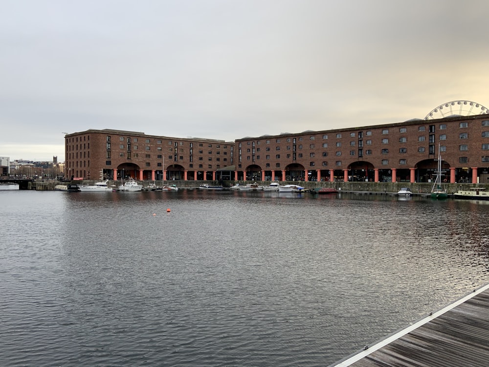 a body of water with a building in the background