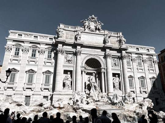 people in front of white concrete building during daytime in Trevi Fountain Italy