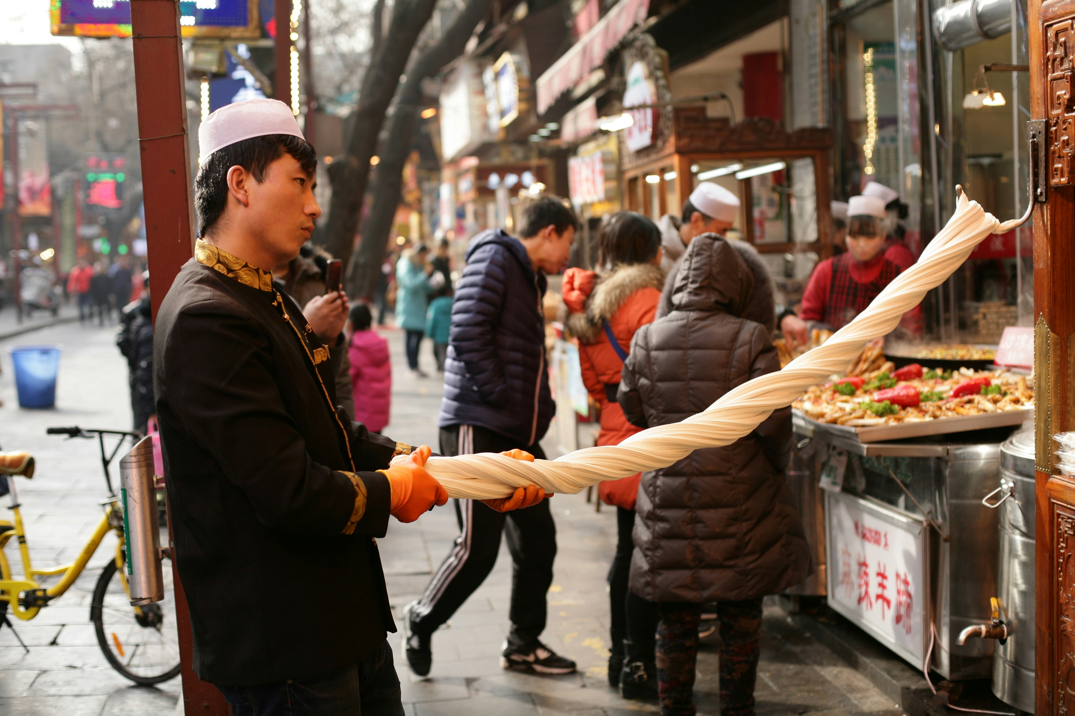 woman in black jacket holding white plastic bag