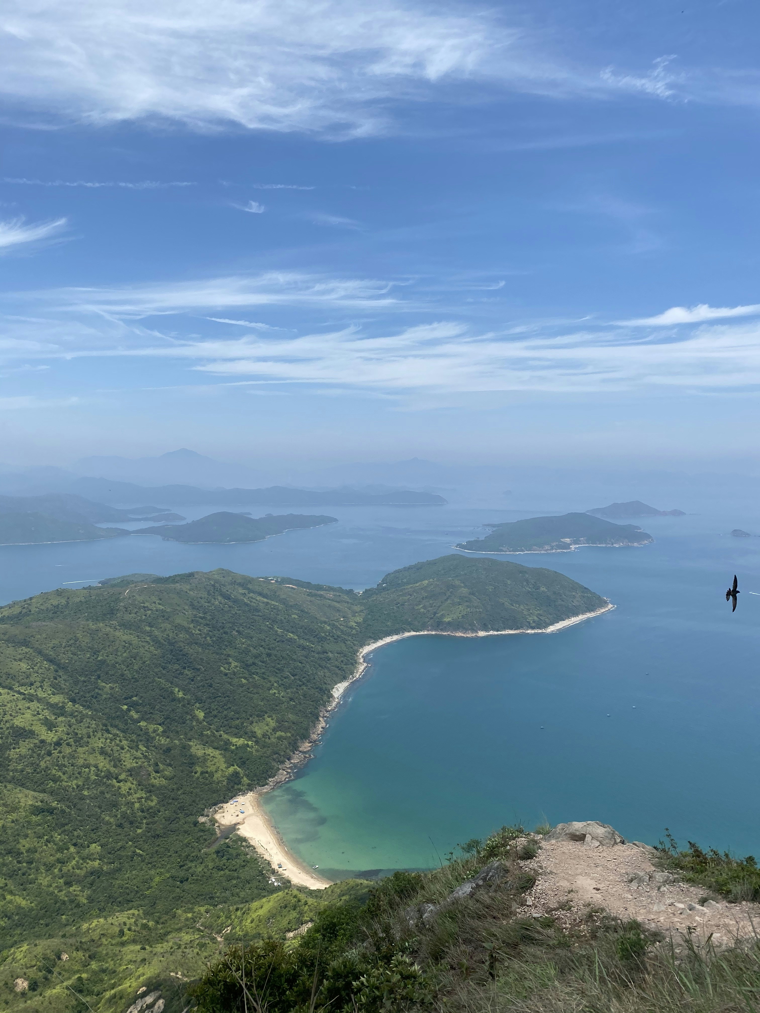 aerial view of green mountains and body of water during daytime