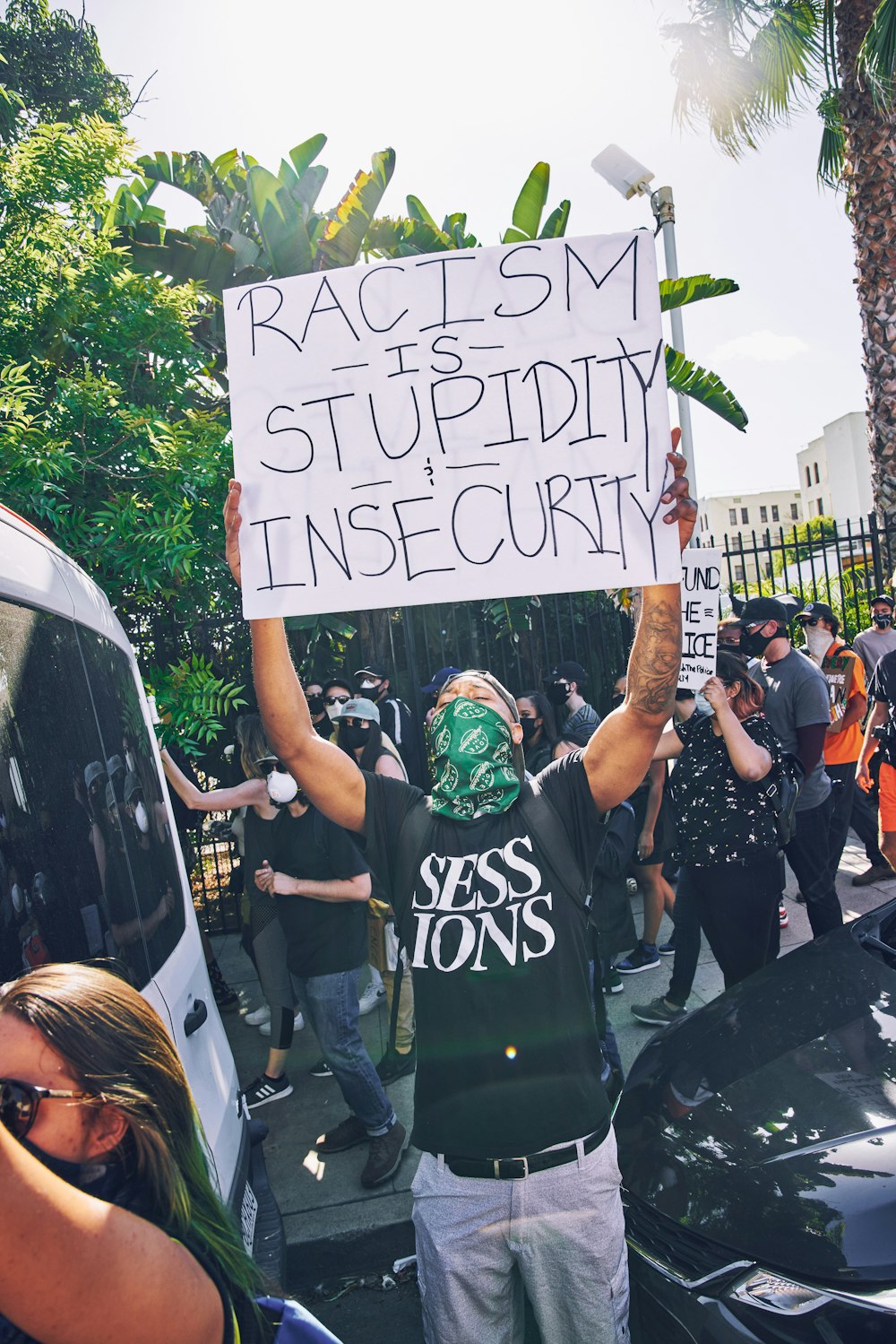 people holding white and black banner during daytime