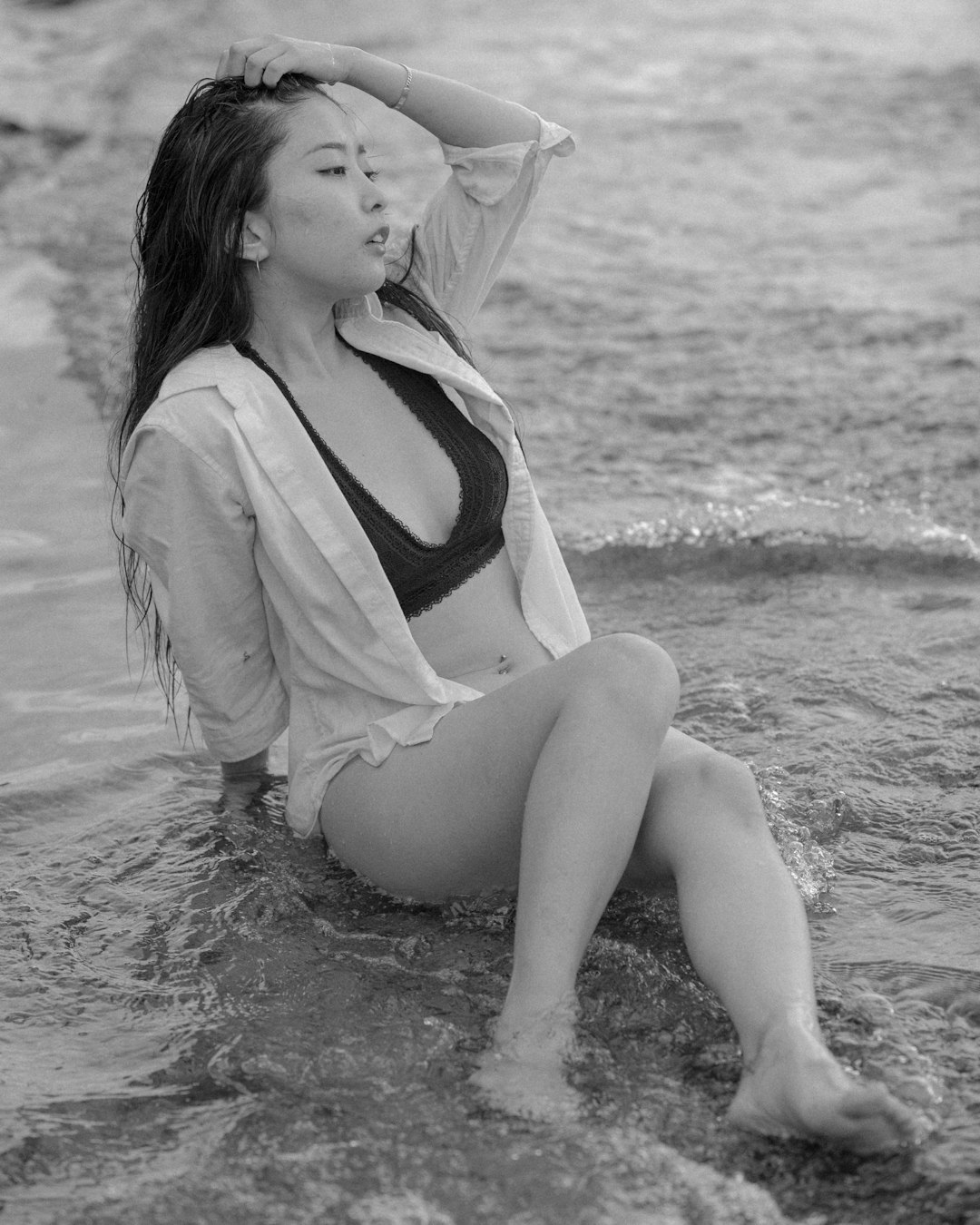 woman in white tank top sitting on beach