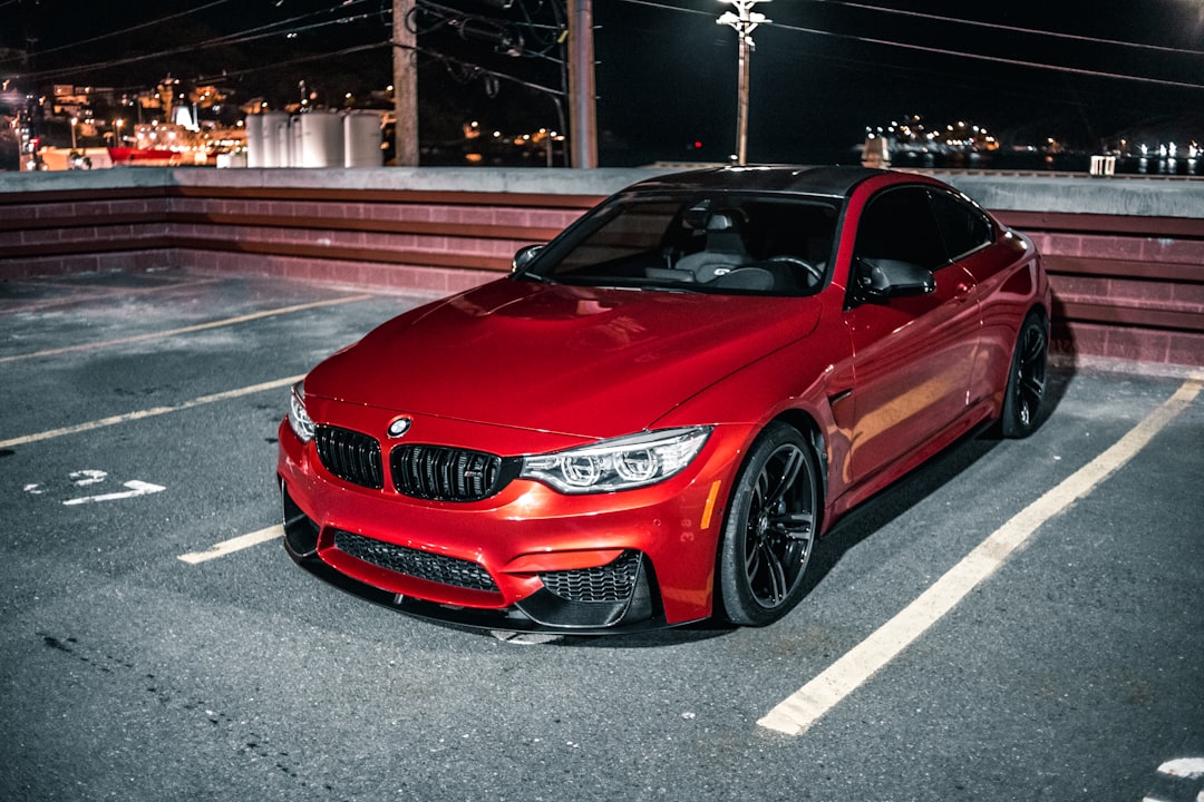 red bmw m 3 parked on parking lot during night time