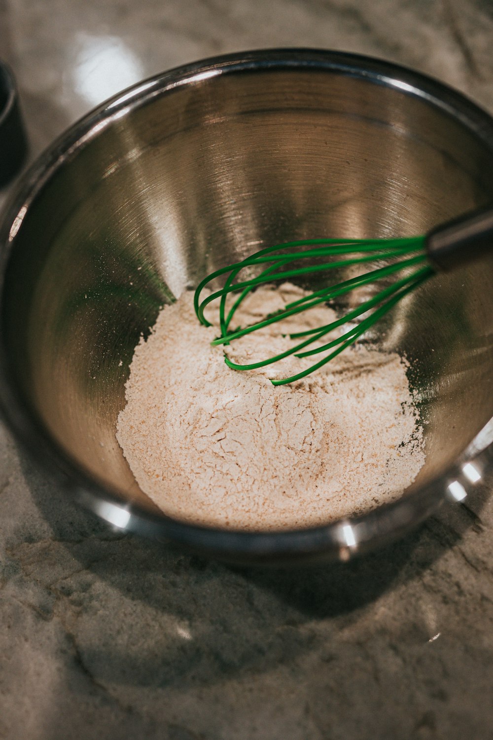 brown powder in stainless steel bowl