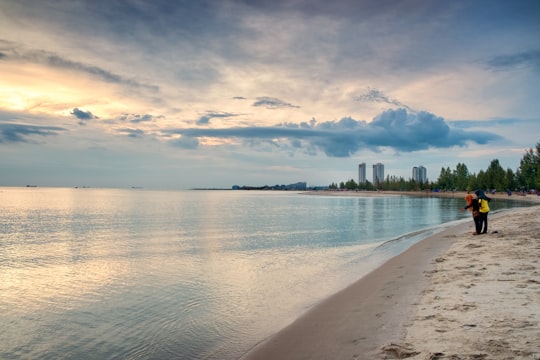 body of water near green trees under white clouds during daytime in Melaka Malaysia