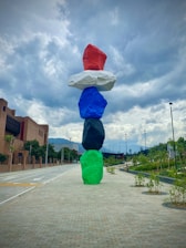 person in green jacket and blue pants holding white umbrella