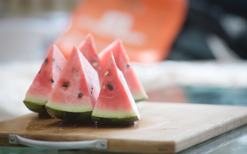 sliced watermelon on brown wooden chopping board