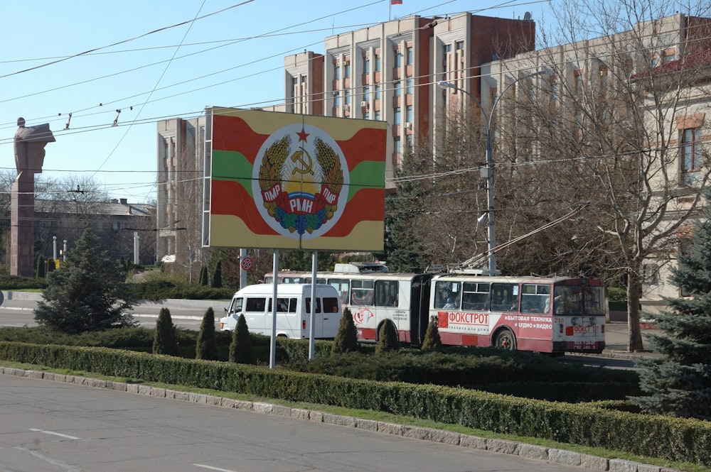 red and white bus on road during daytime