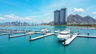 A panoramic view of yachts docked at Real Club Náutico Valencia under a clear blue sky.