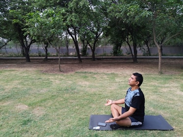 A serene outdoor setting where someone is doing yoga with a tablet nearby.