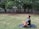 man in blue crew neck t-shirt sitting on gray wooden bench during daytime